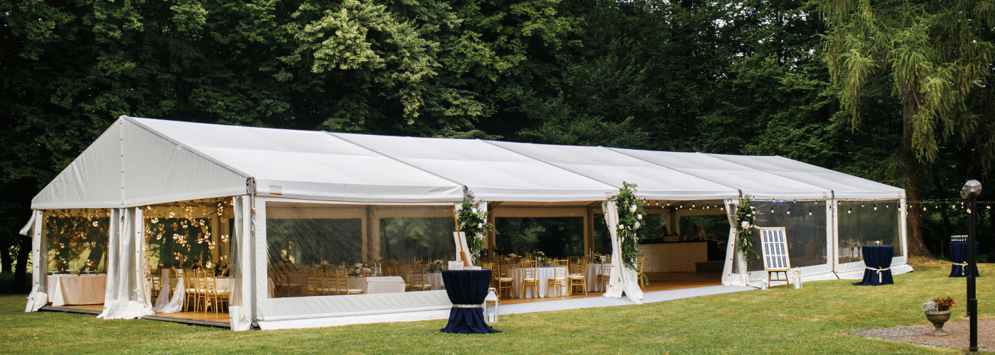 Wedding marquee setup in a UK garden with chairs and decor