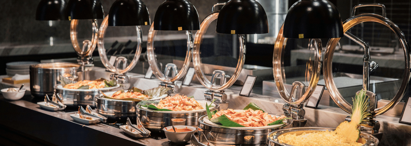 Professional wedding catering setup with serving trays and a clean pass
