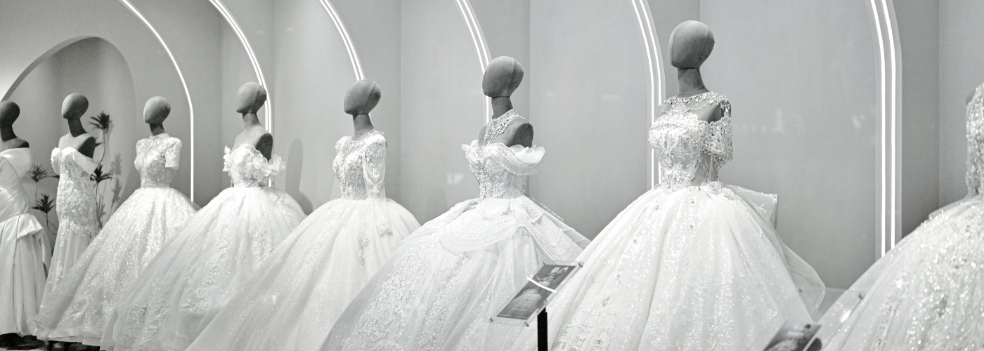 Flat lay of bridal and groom outfit details with fabric swatches and a personalised item